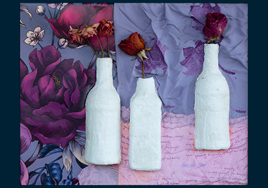 Three white bottles, each with a red rose, placed on a pink table with white and red flowers on a purple background